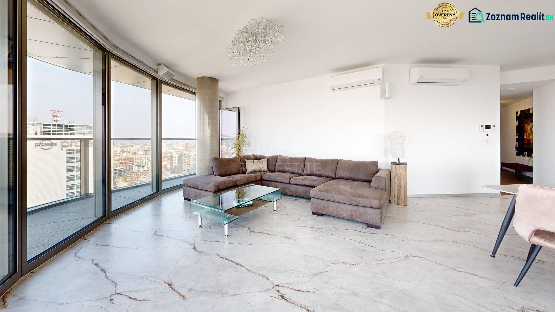 Living room of a 3-room apartment with a large window, corner sofa, and floor with wood decor.
