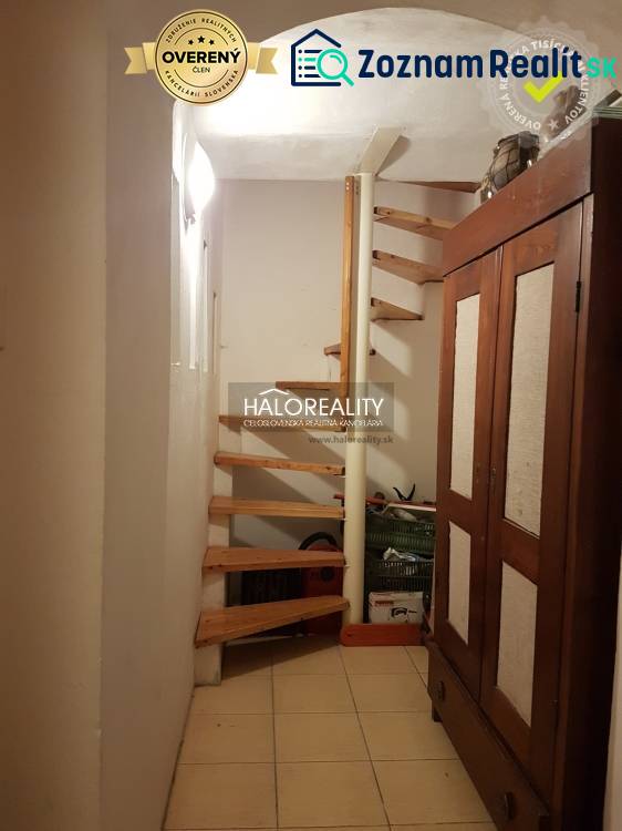 A spiral staircase with a wooden decor in a family house.