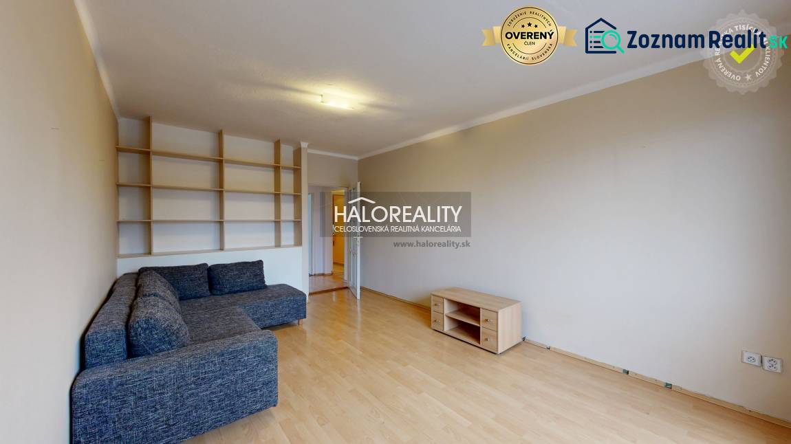 Living room with a sofa and built-in shelves in a 2-room apartment.