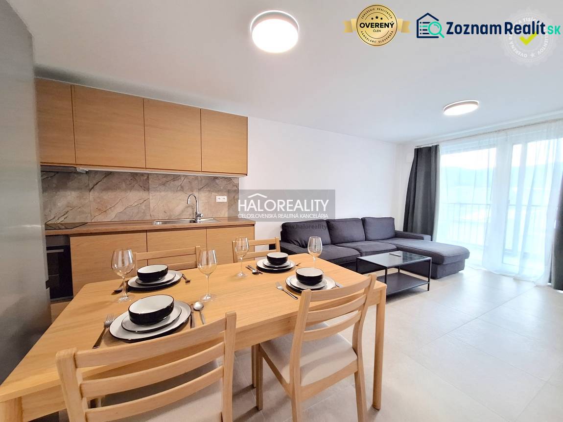 A kitchen in a 2-room apartment with wooden decorative cabinets and a set table.