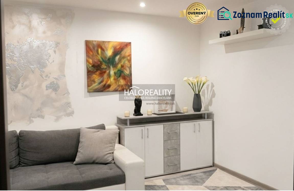 Living room in a 3-room apartment with modern wall decoration and a comfortable sofa.