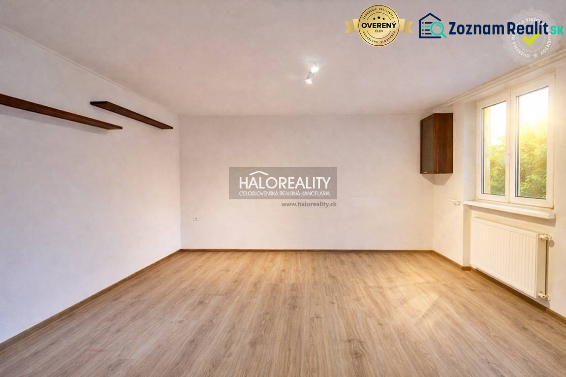 A spacious room with a light wood-patterned floor in a 4-room apartment.