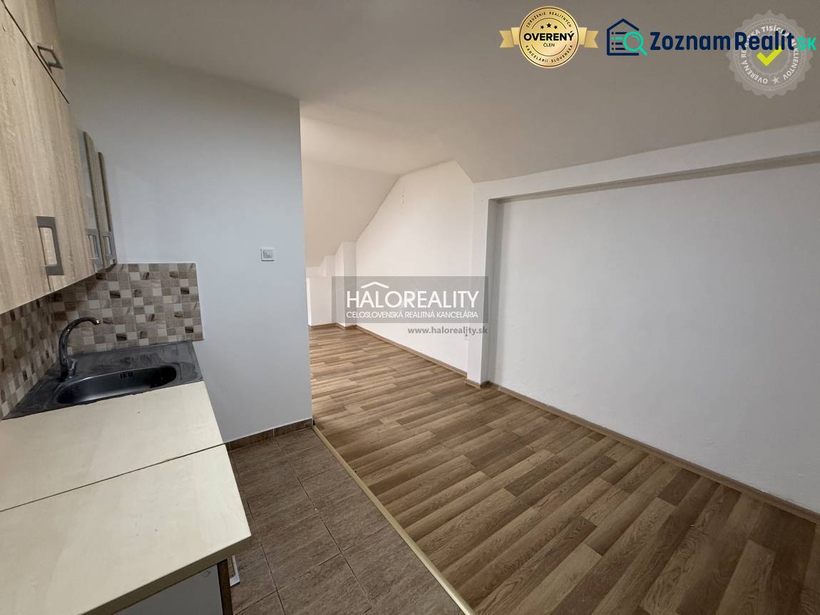 Studio apartment with a kitchenette and a wooden decor floor.