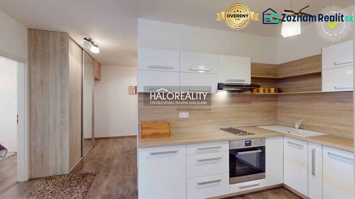 A kitchen in a 3-room apartment with a built-in kitchen unit and a built-in wardrobe, wooden floors.