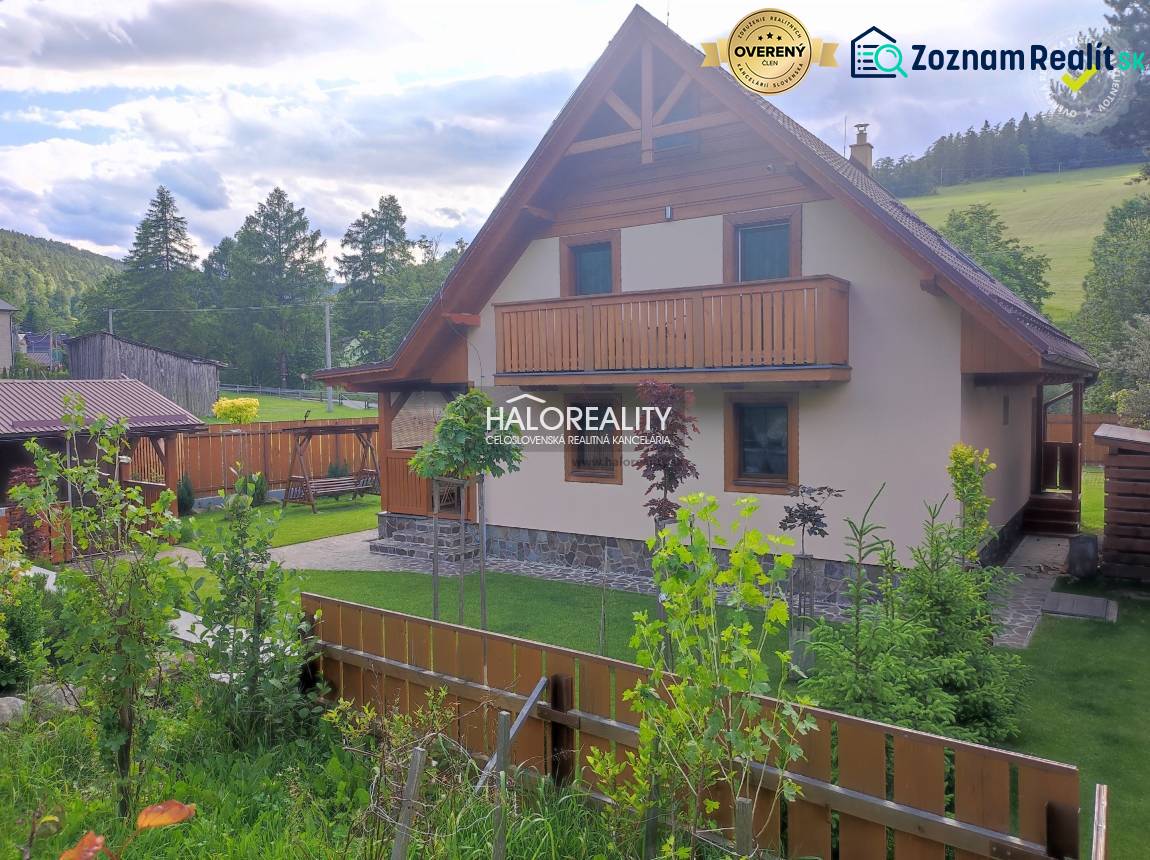 A cabin in Jezersko with wooden cladding and a landscaped garden, surrounded by greenery.
