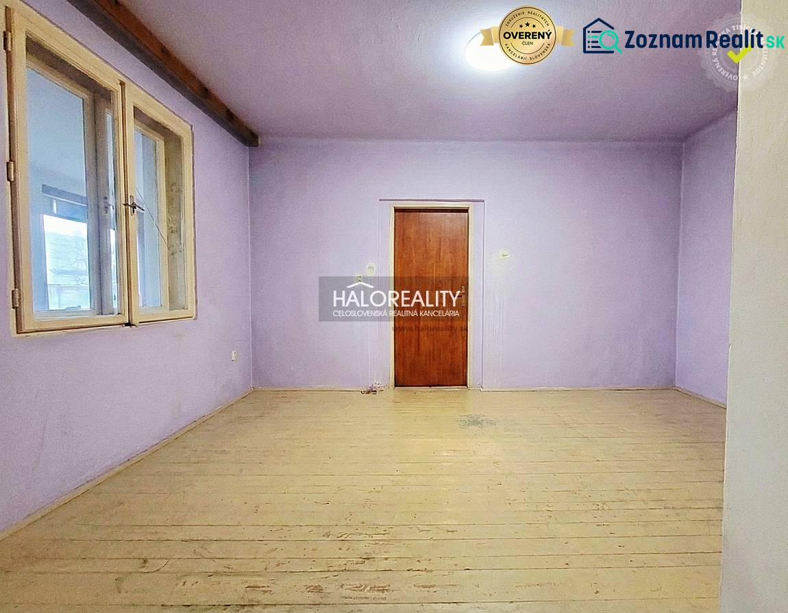 A room in a family house with purple walls and a wooden decor floor.