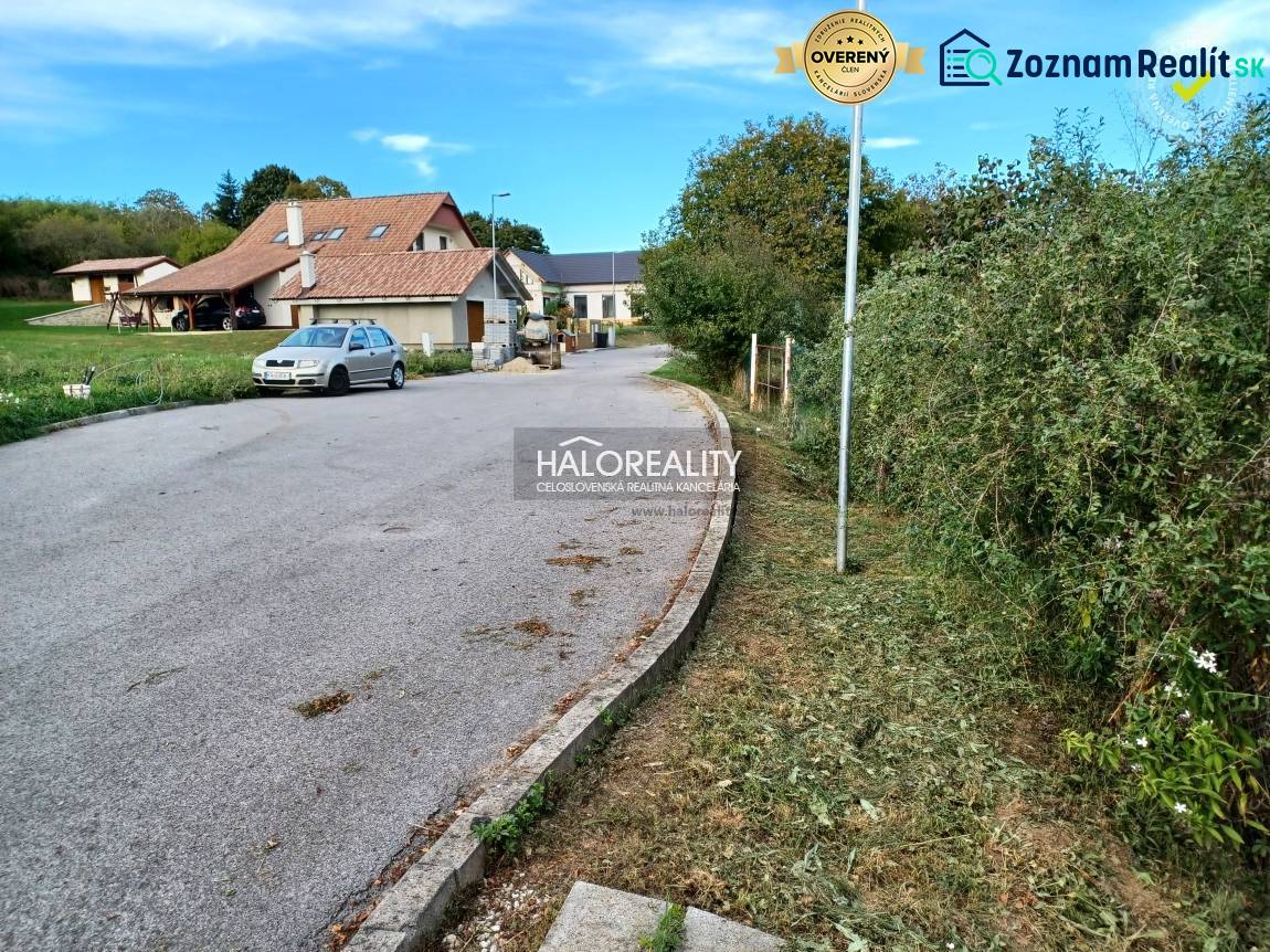 A family house in the village of Terany, surrounded by gardens and a paved road.