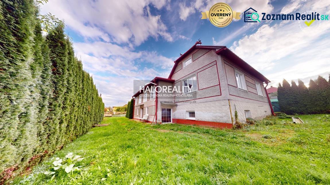 A family house in Hrachovo with a well-maintained lawn and a hedge.