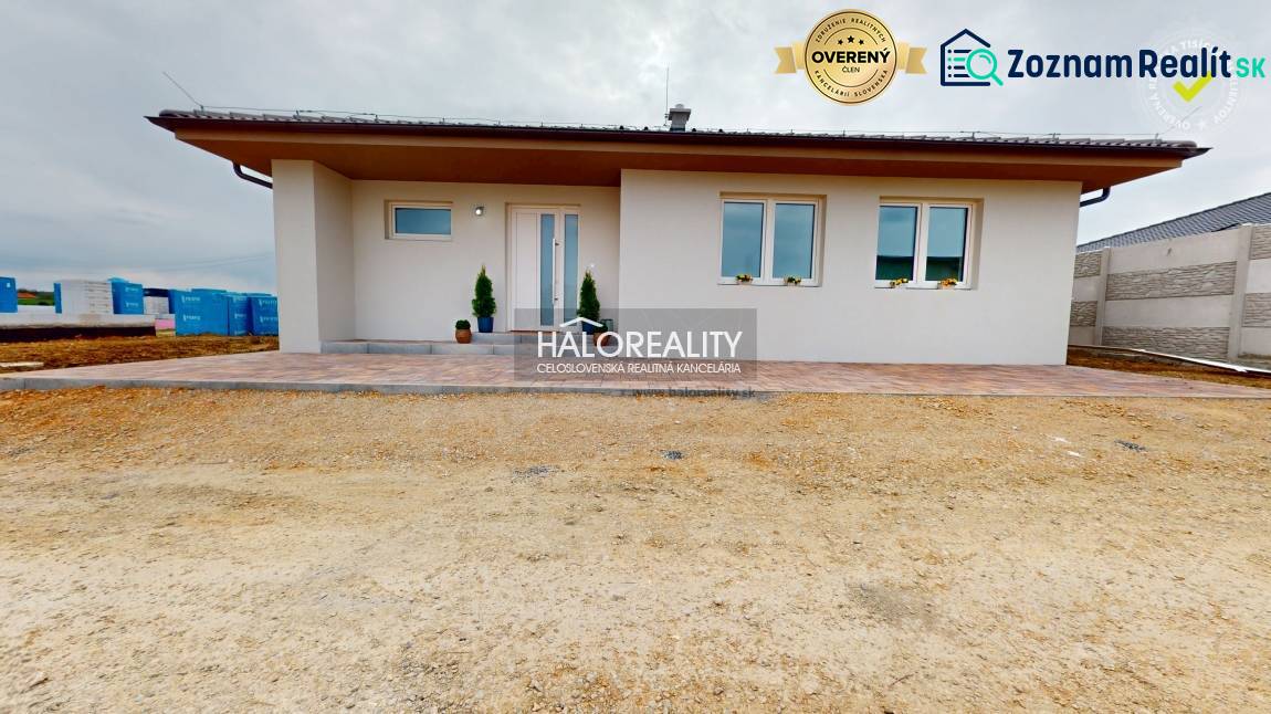 A family house in Rimavské Janovce with a white facade and a terrace in the front yard.