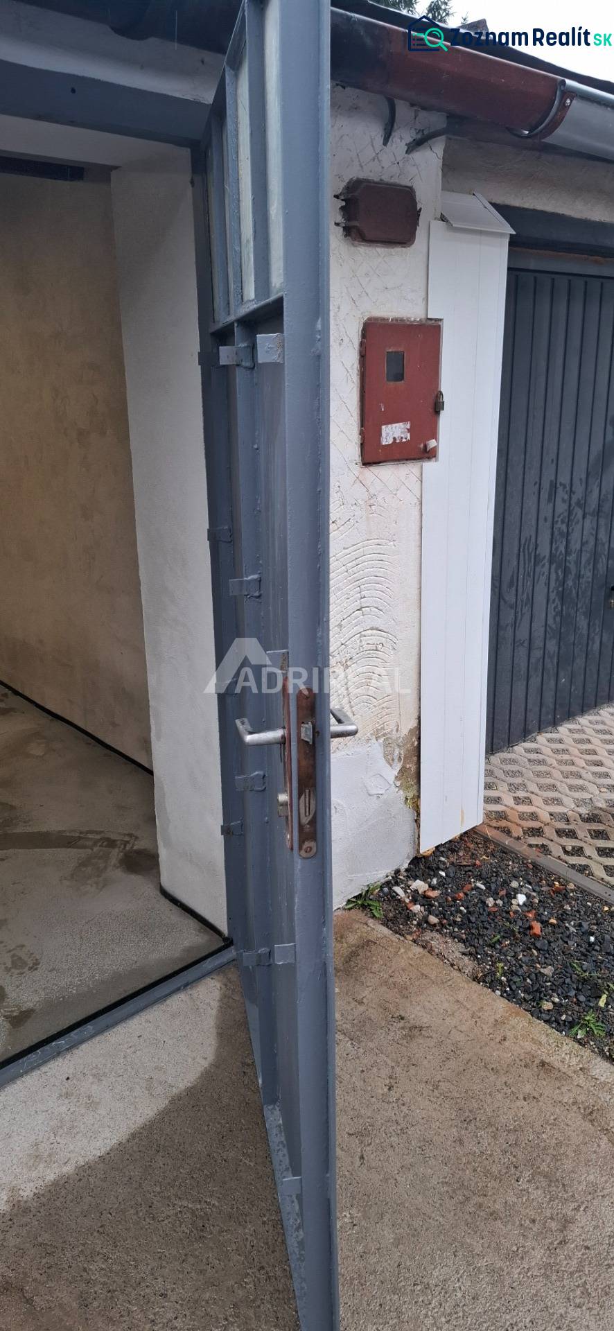 Open metal gate in the garages on Prachatická Street in Zvolen.