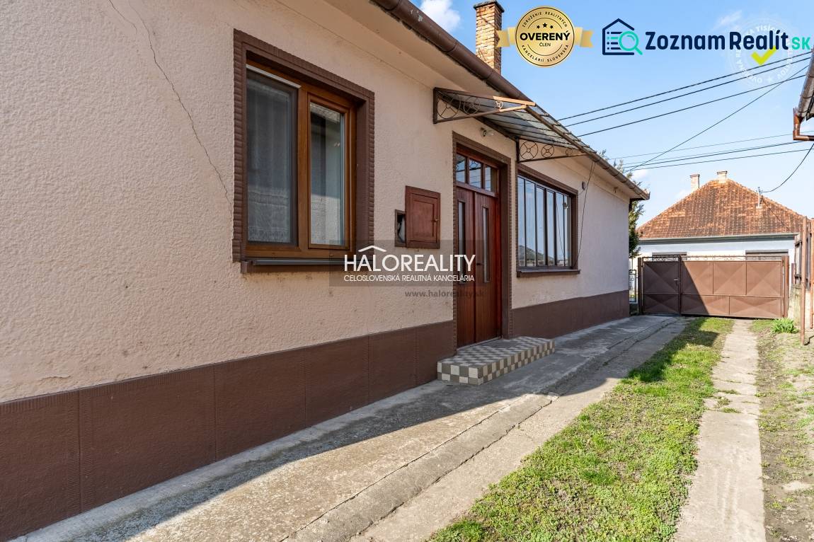 A family house in Horná Potôň with a simple facade and a yard with green lawn.