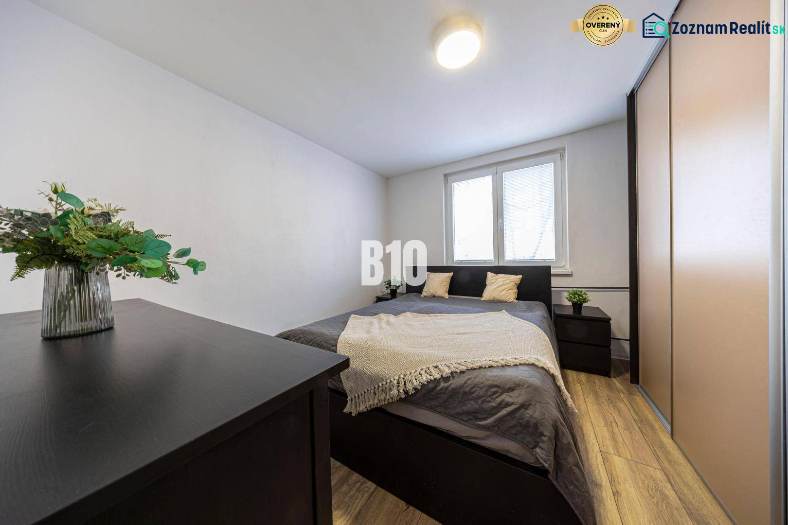 Bedroom with a double bed, wardrobes, chest of drawers, wooden decor flooring, 3-room apartment.