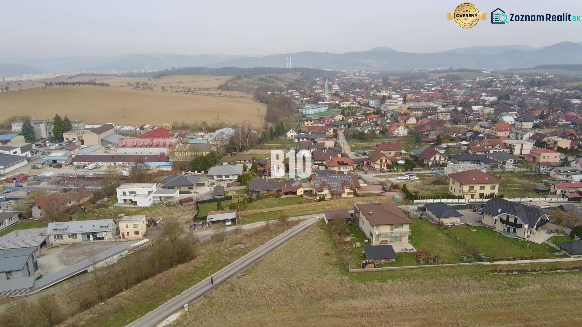 Aerial view of a residential area in Rosina with houses and greenery. Plots - housing.