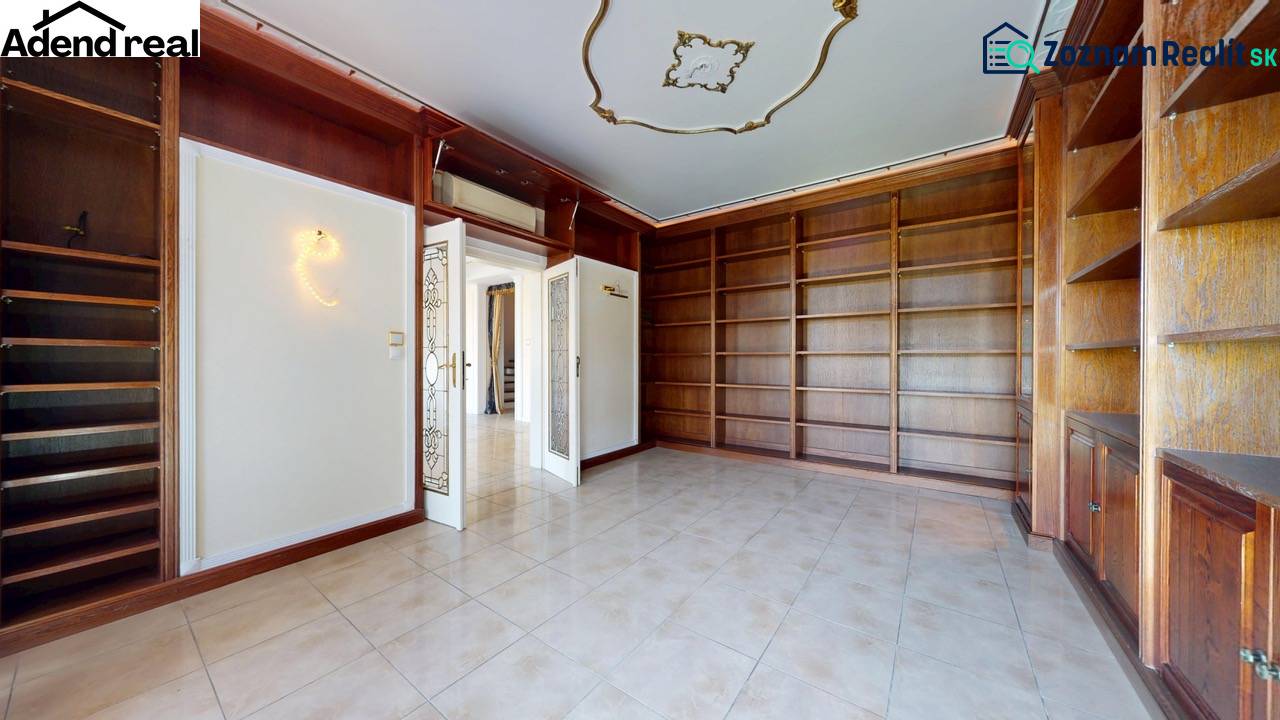 A library with spacious shelves and ceramic tiles in a 5 or more room apartment.