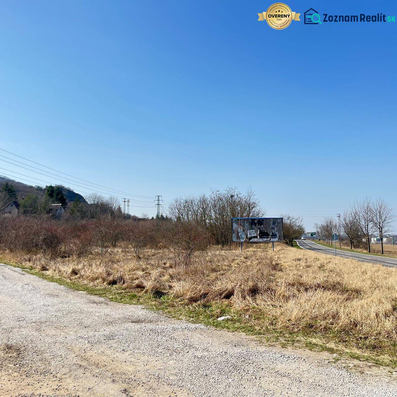 Commercial land in Bratislava - Devínska Nová Ves, next to the road, bordered by shrubs.
