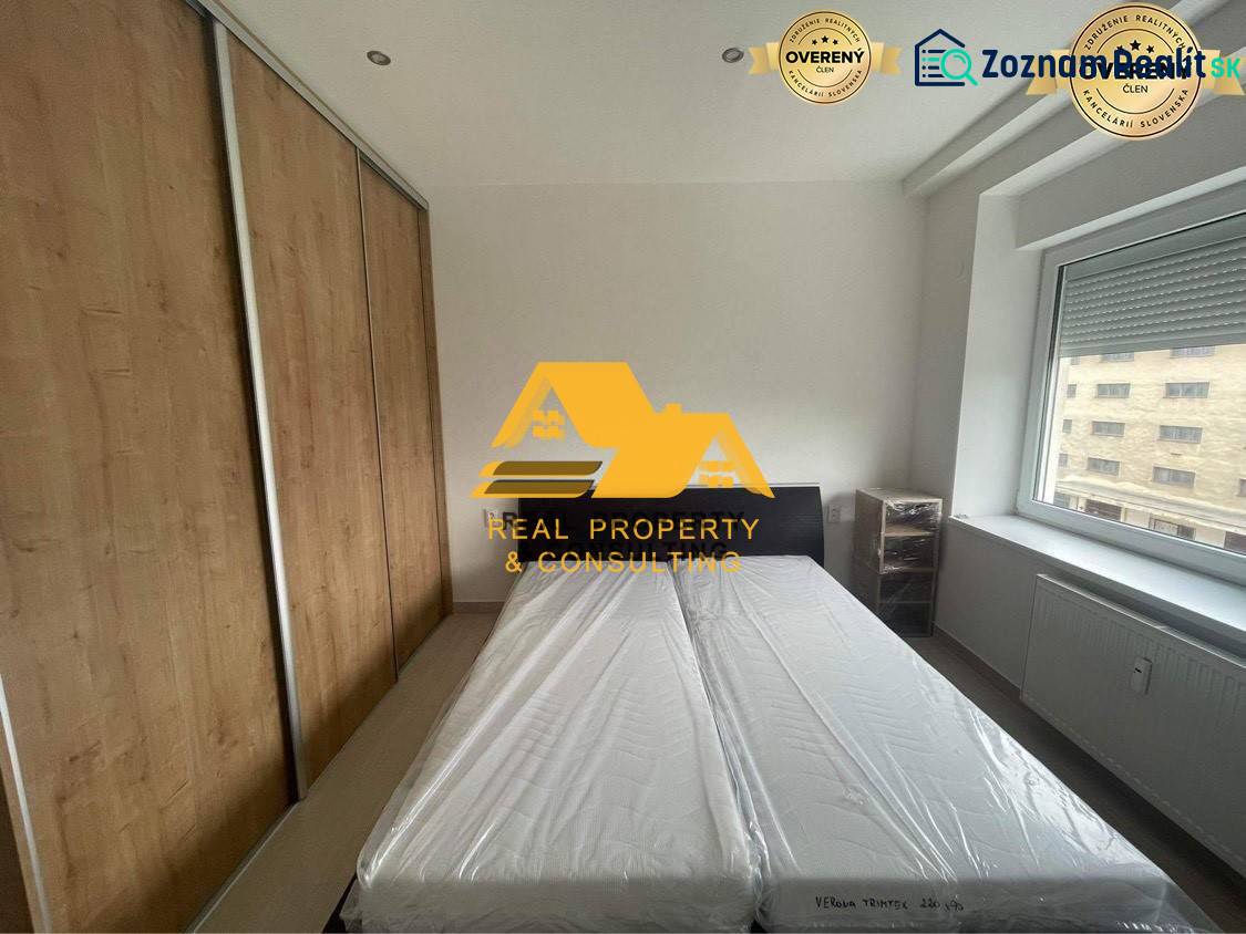 Bedroom in a 3-room apartment with a bed, built-in wardrobe, and a window with a view.