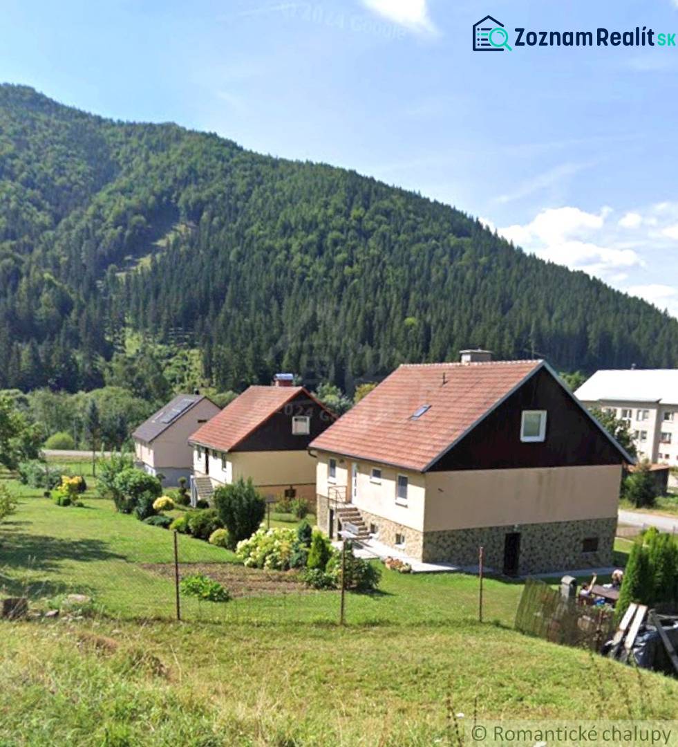 Family houses in Liptovské Revúce with mountain scenery and gardens.