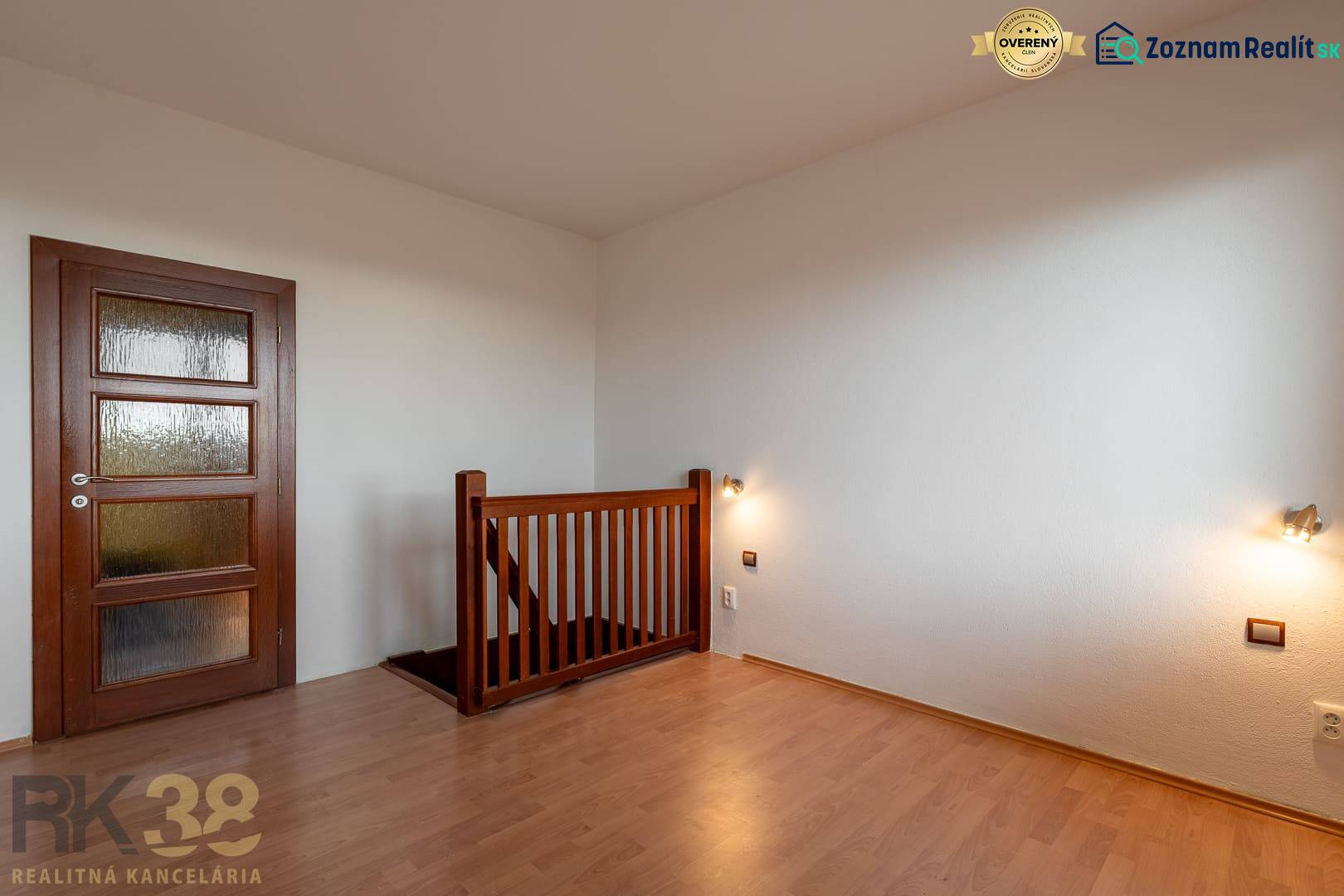Interior of a 5 or more room apartment with wood-patterned flooring and a staircase.