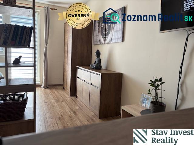 Interior of a 1-room apartment with wooden decor furniture and art on the wall.