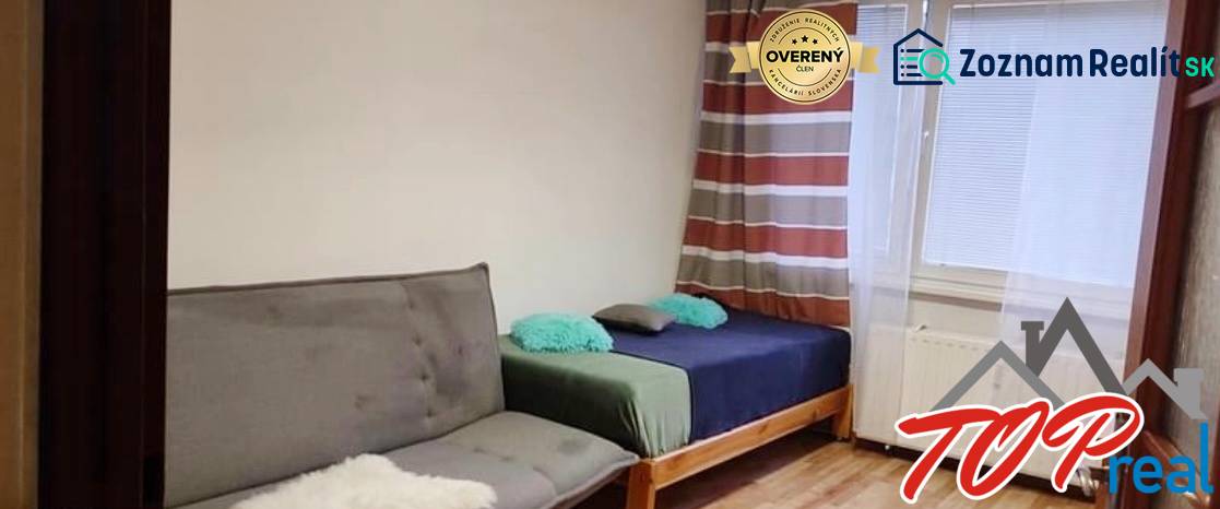 A room in a 3-room apartment with a sofa and a bed, near the window.