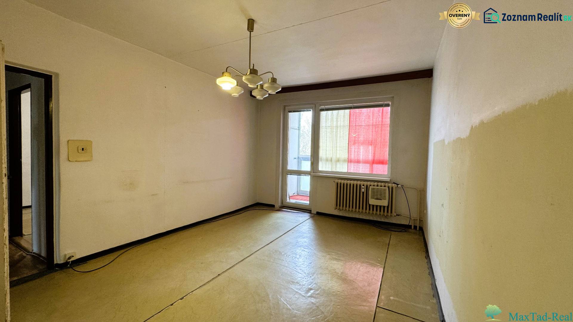 A room in a 3-room apartment with a balcony, simple walls and lighting.