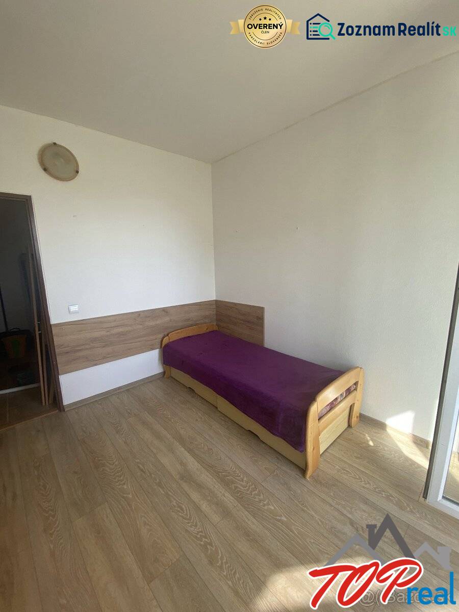A bedroom with light furniture, a single bed, and a floor with a wooden decor in a 4-room apartment.