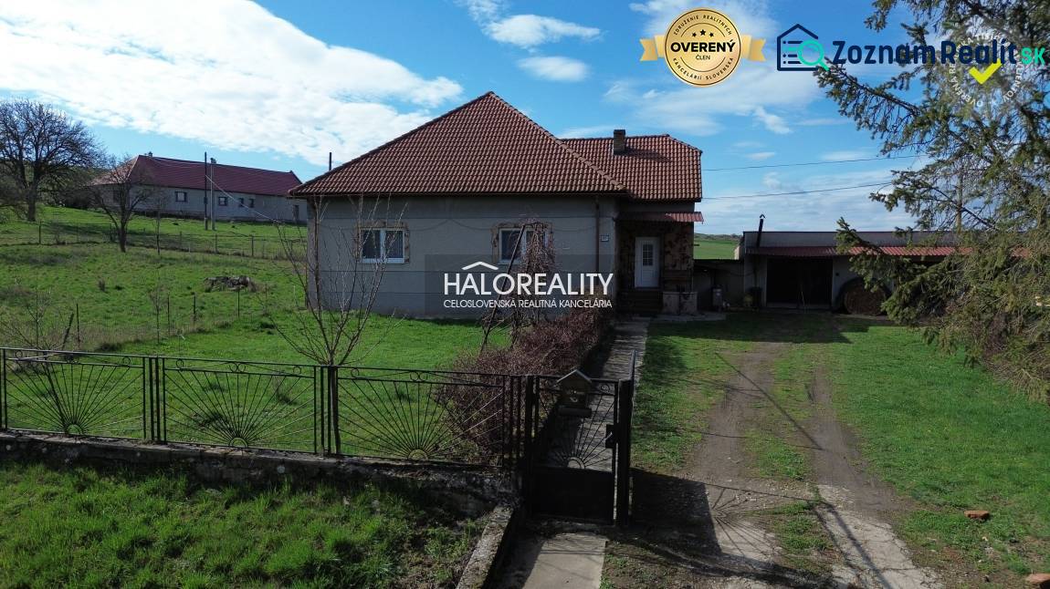 A family house in Rimavské Janovce on a plot with green lawn and fencing.