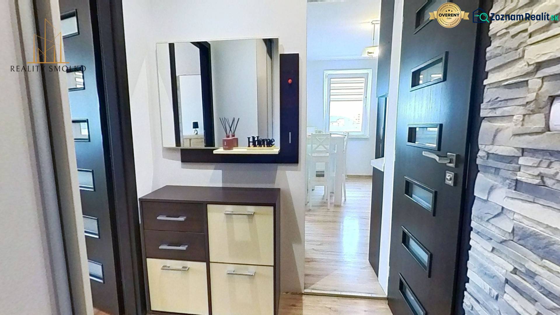 A hallway with wooden decor and paneling in a 3-room apartment, a cabinet with a mirror.
