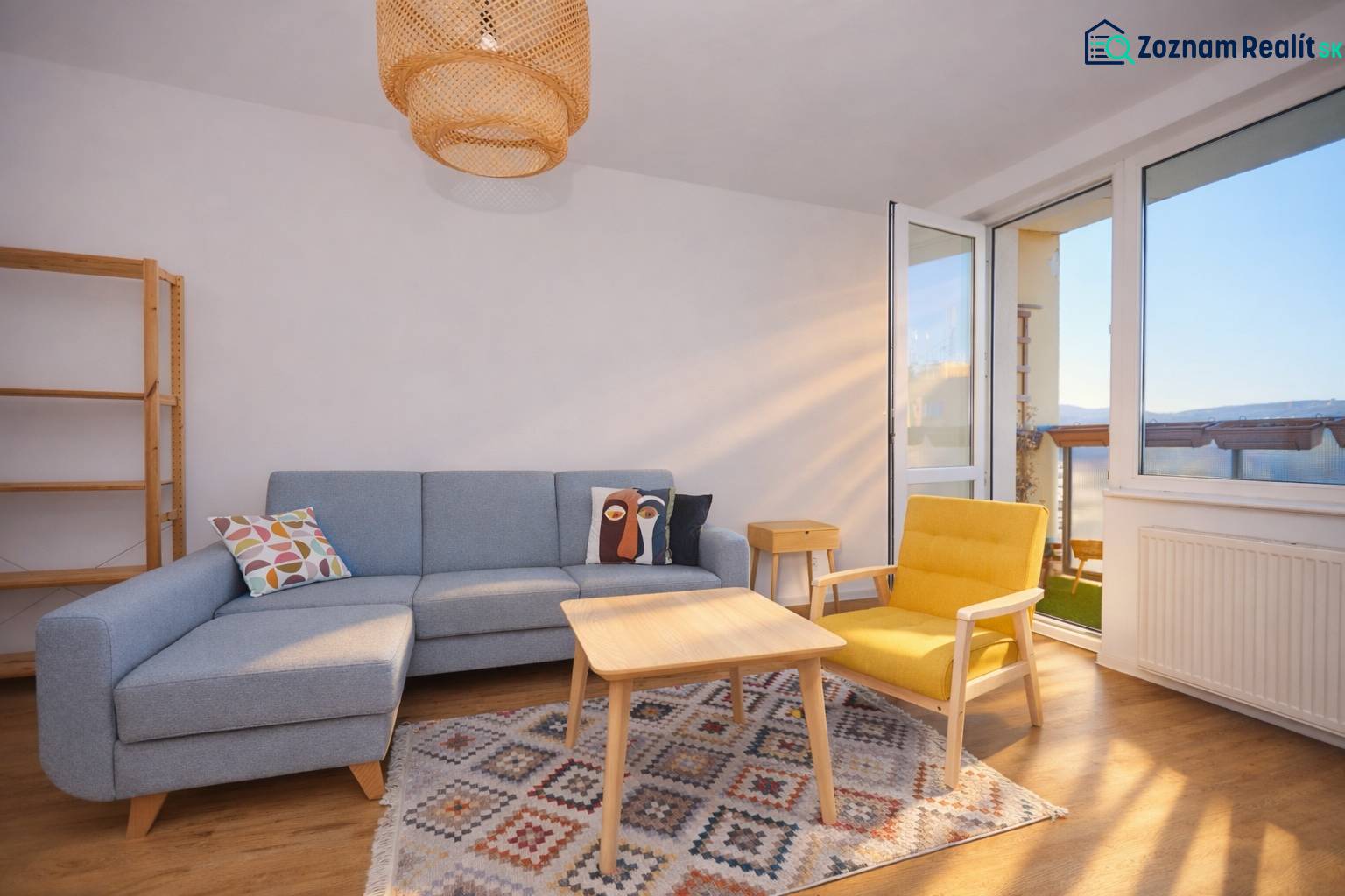 Living room with a sofa, yellow armchair, carpet, and wooden decor flooring in a 3-room apartment.