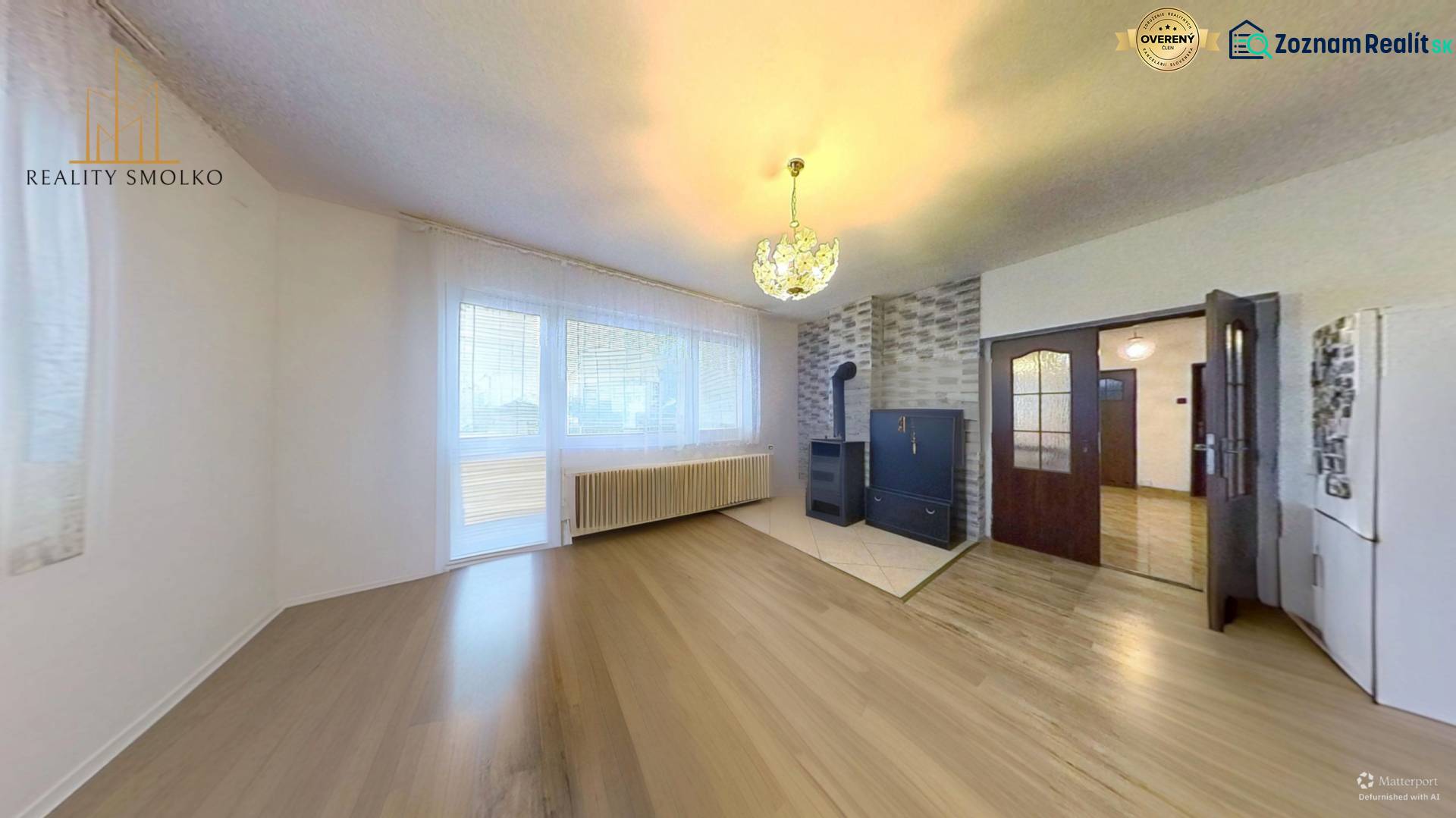 Living room in a family house with a wooden decor floor and a stove.