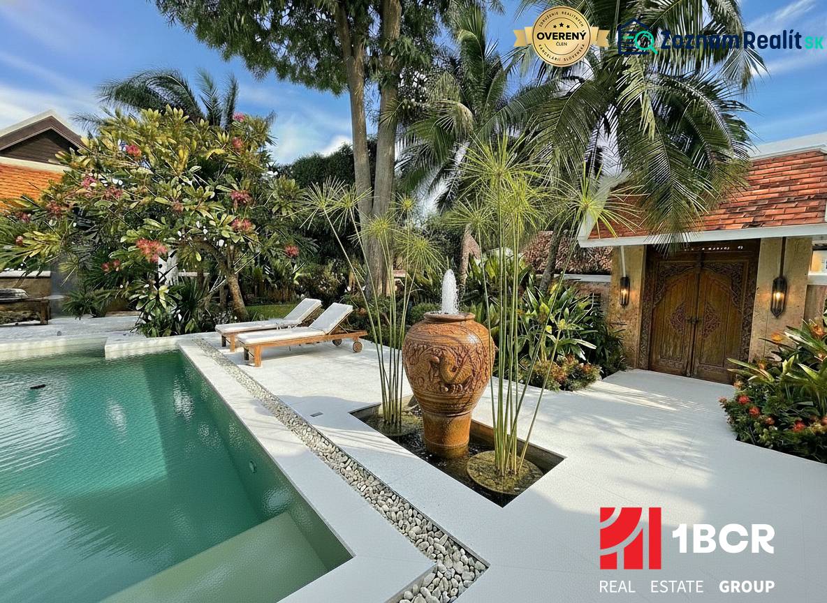 A view of a luxury villa in Pattaya with a pool and exotic garden.