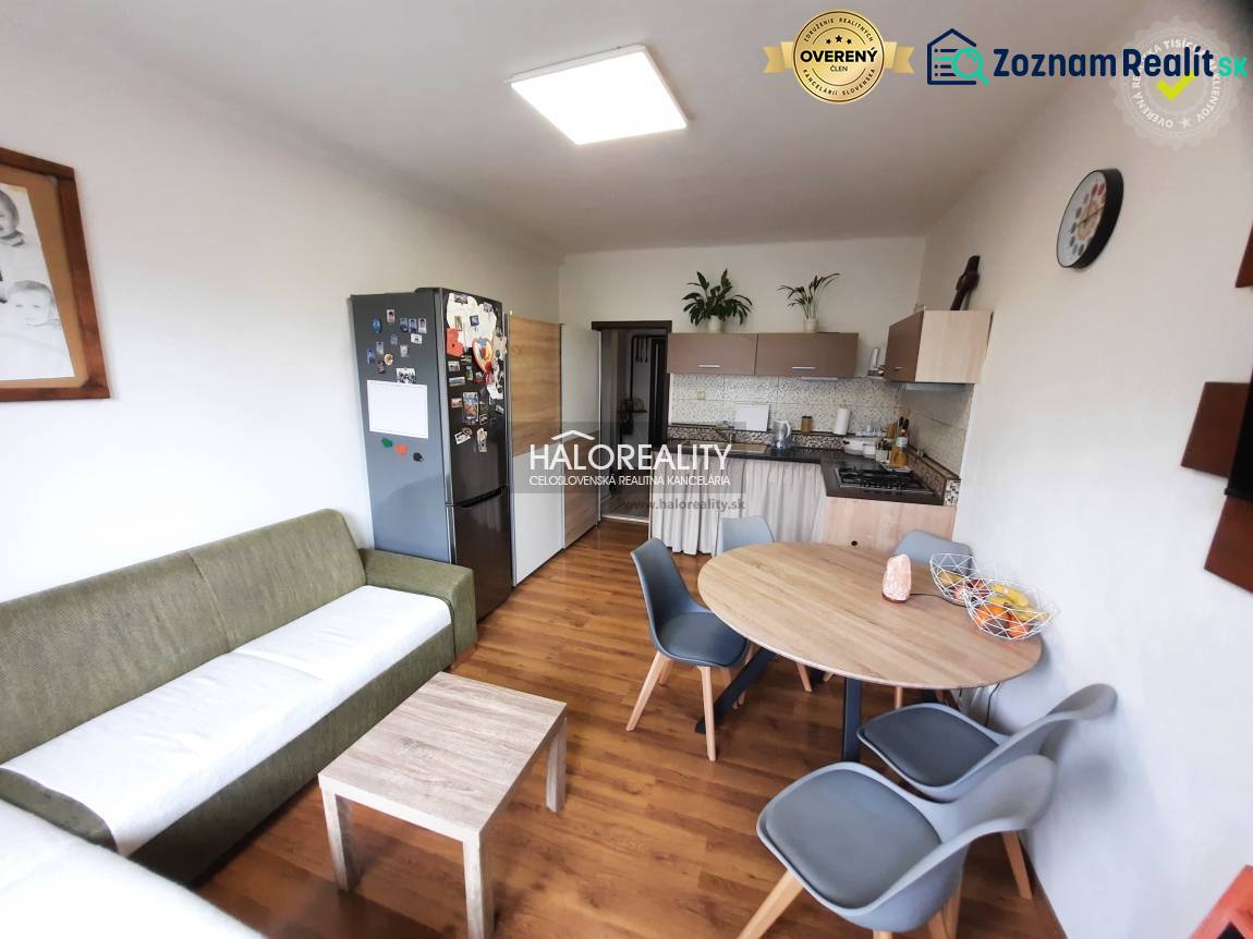 Living room with kitchen, wooden decor flooring, 3-room apartment, dining table and chairs.