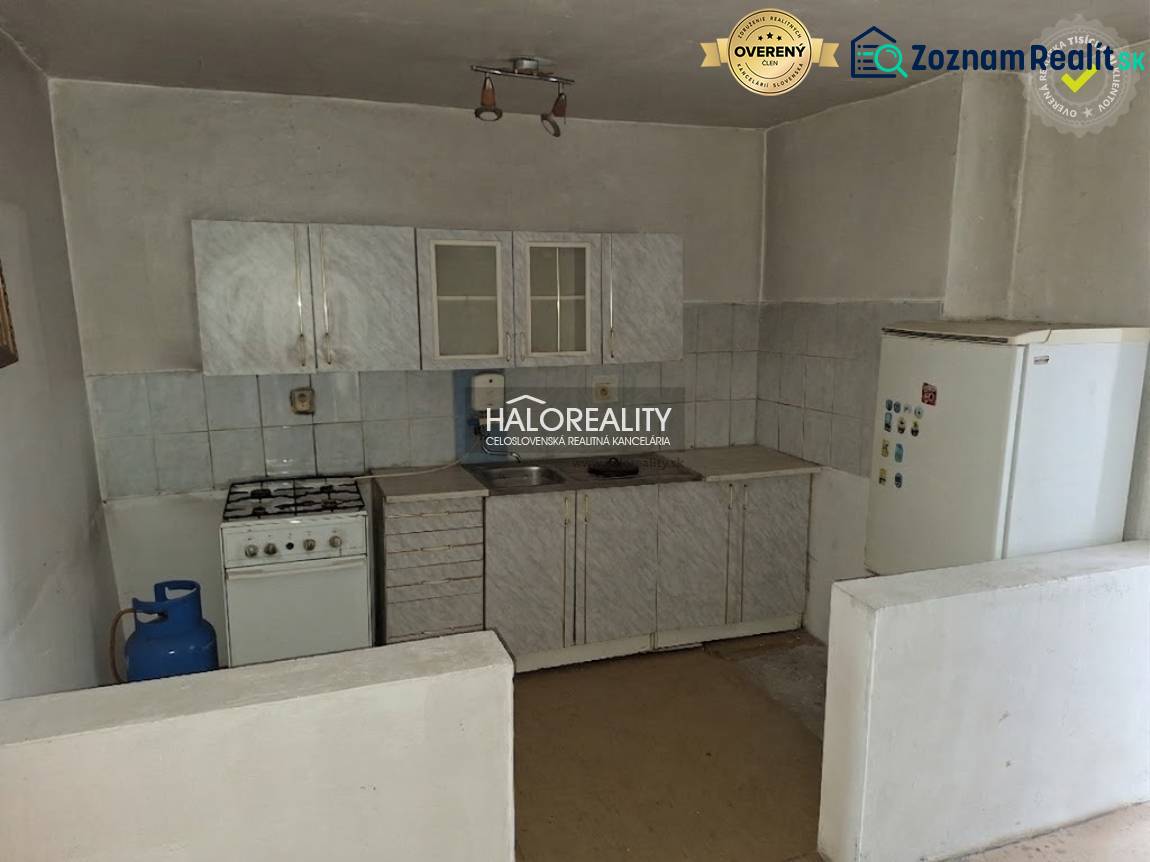 Kitchen unit with a gas stove and refrigerator in the interior. Land - housing.