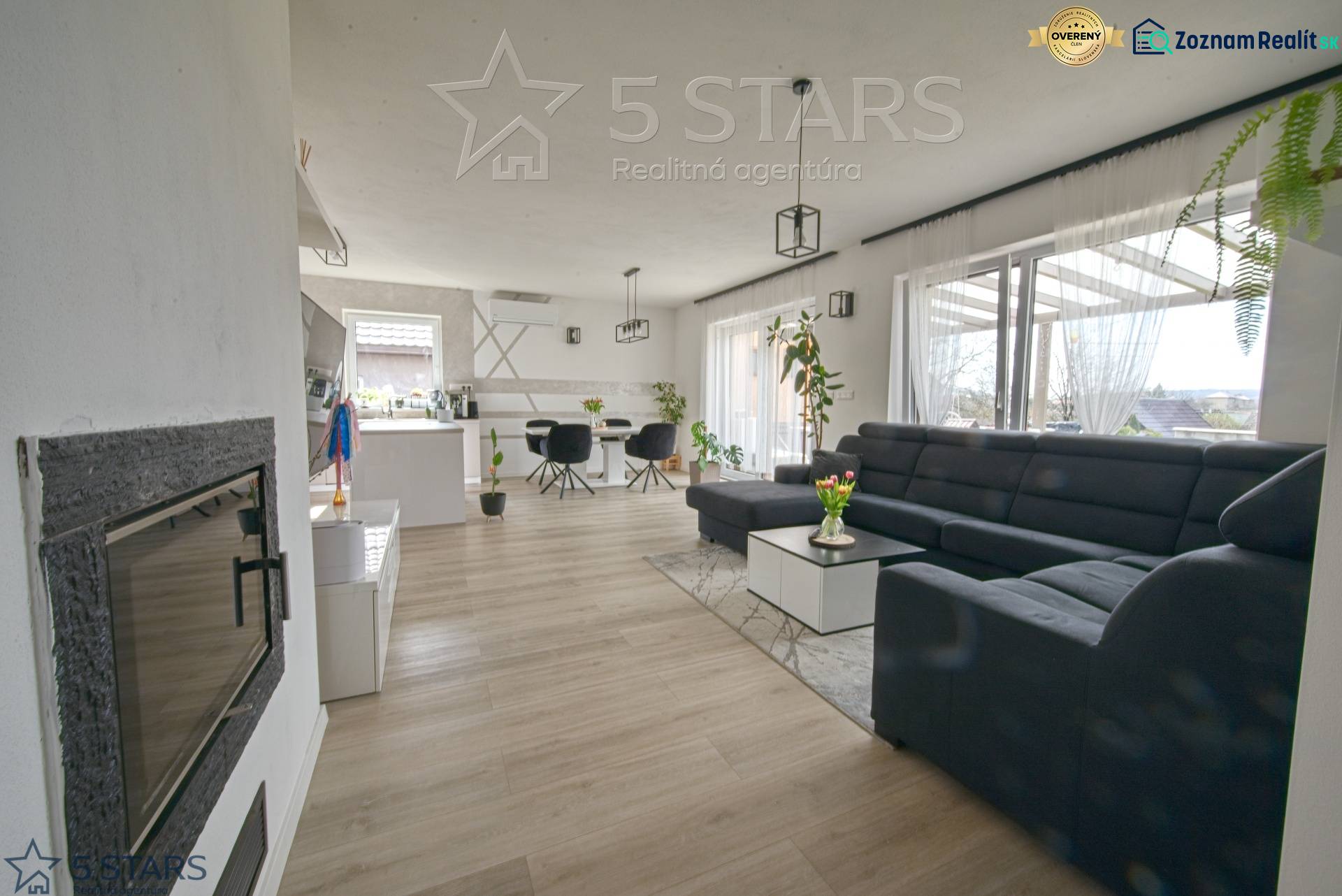 Living room in a family house with a large sofa and a wooden decor floor.