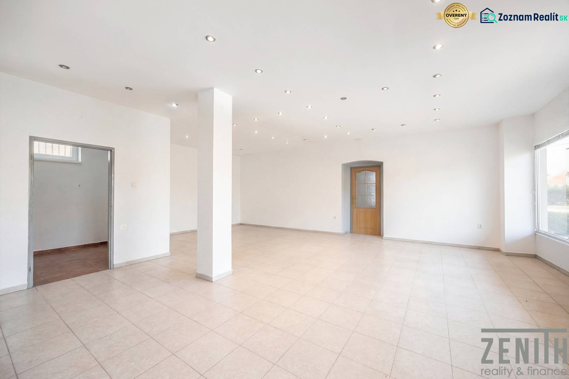 Spacious commercial spaces with white walls, tiles, and illuminated ceiling lights.