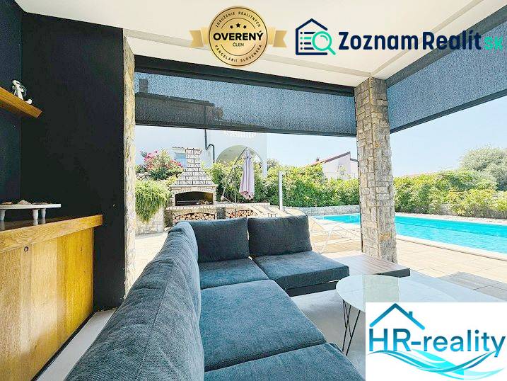 The exterior of the villa in Jakišnica with a swimming pool, seating area, and garden fireplace.