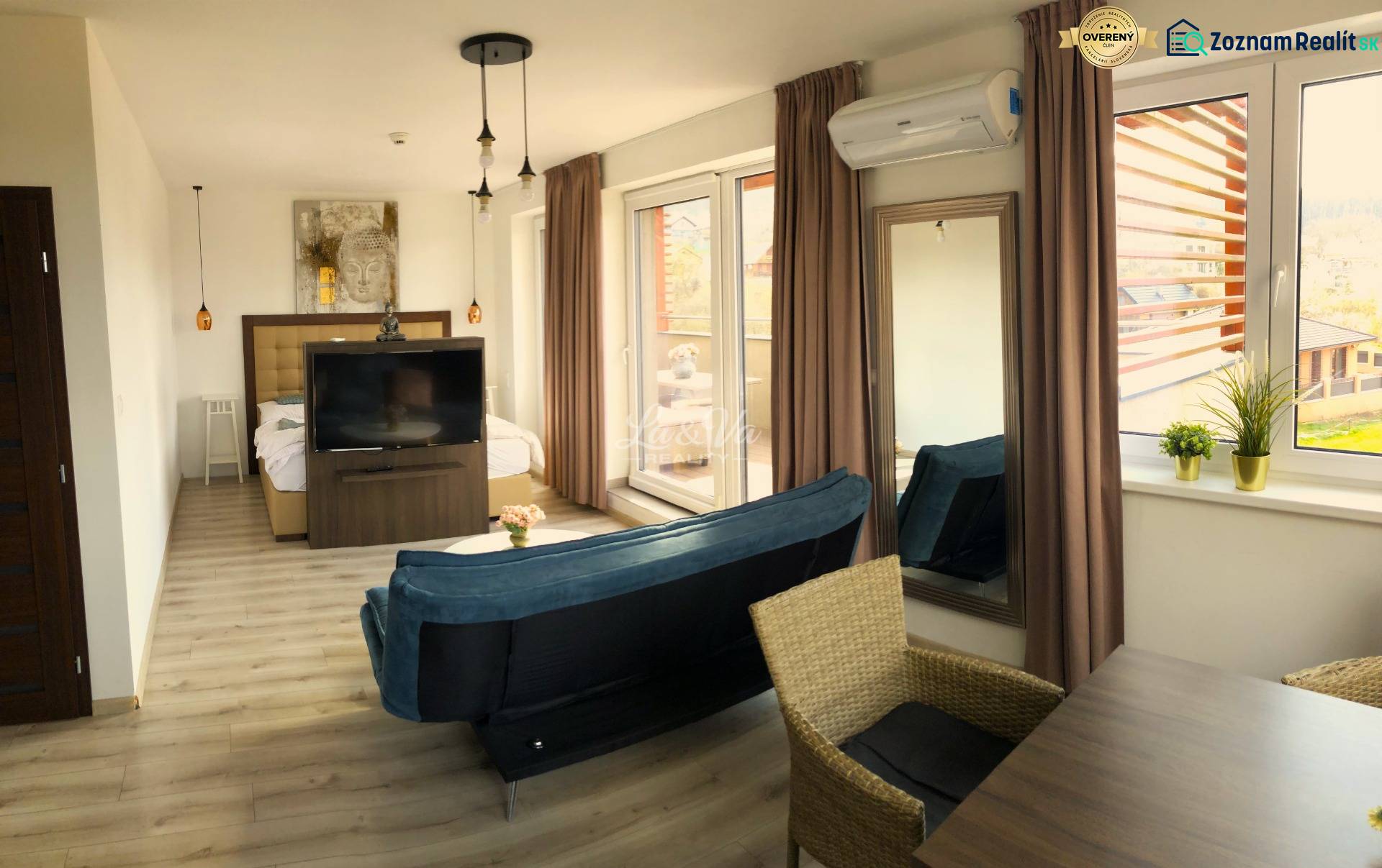 Bright 2-room apartment with wood-patterned flooring, a sofa, and large windows.