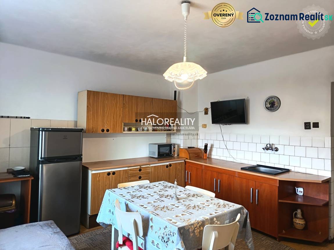 A kitchen in a family house with wooden kitchen furniture and a dining table.