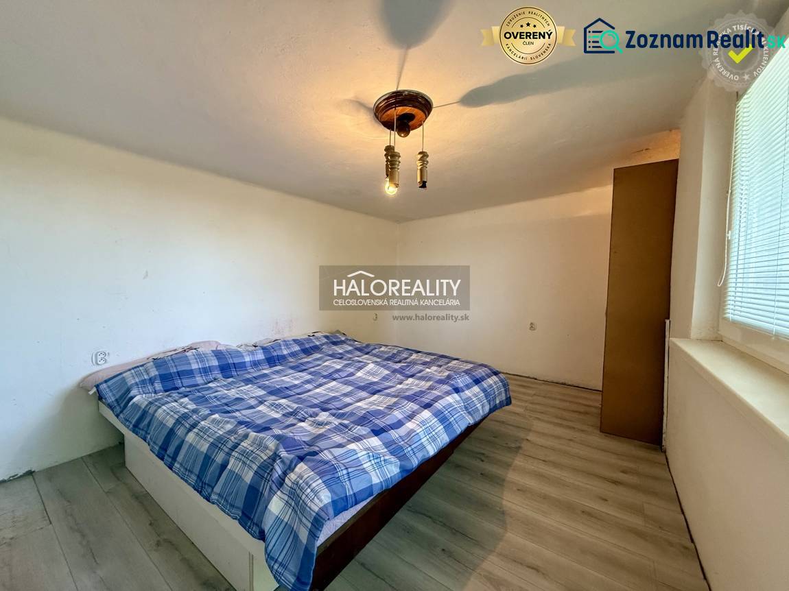 A peaceful bedroom with a simple bed and a wooden decor floor.