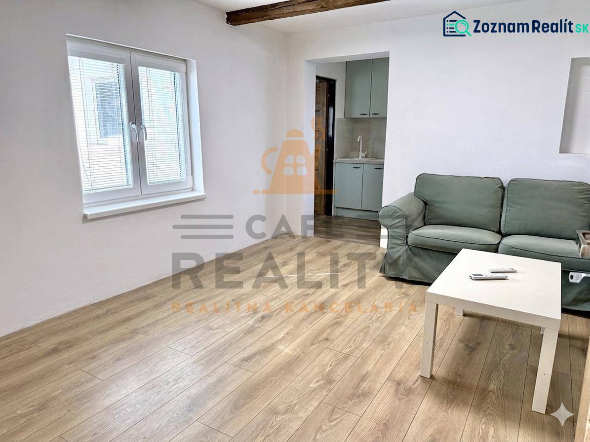 Living room in a family house with a sofa, table, and floor with wooden decor.