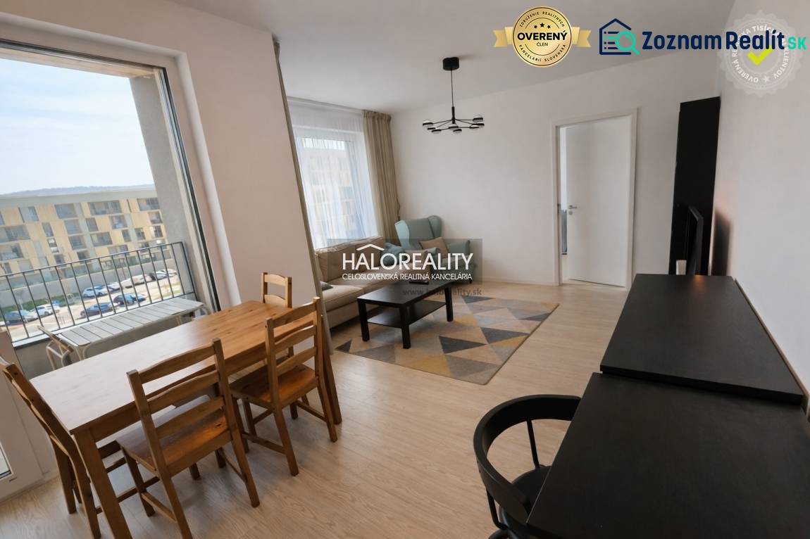 Living room in a 2-room apartment with a balcony, wooden decor flooring, dining table.