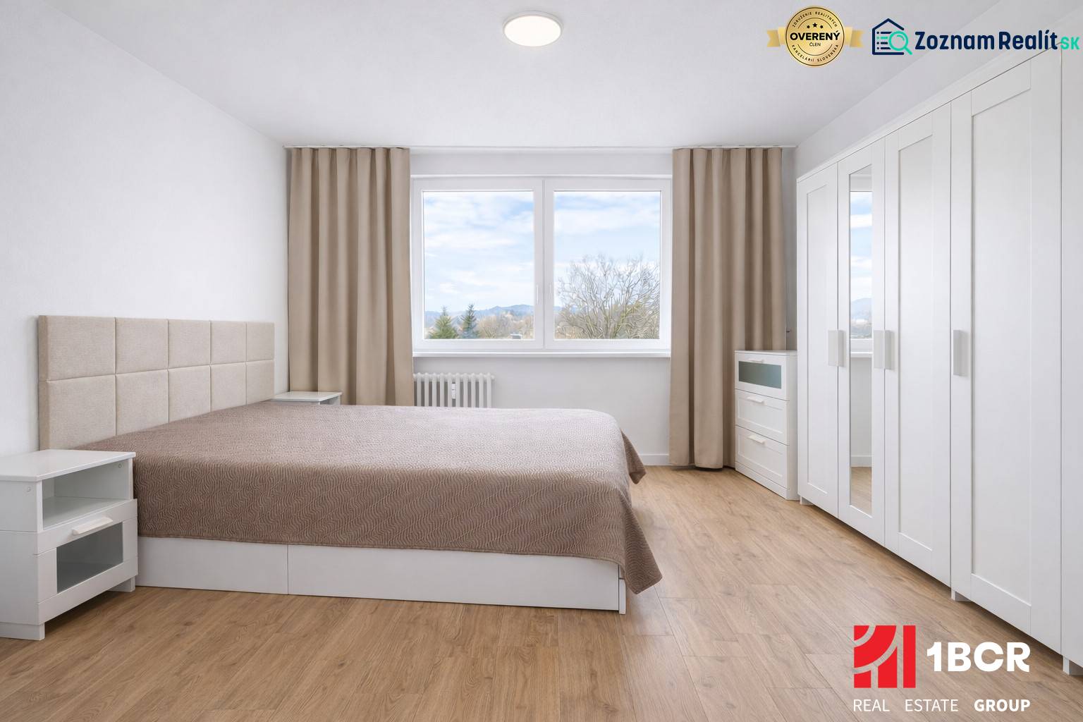 Bedroom with a double bed, wardrobe, and wooden decor flooring in a 2-room apartment.