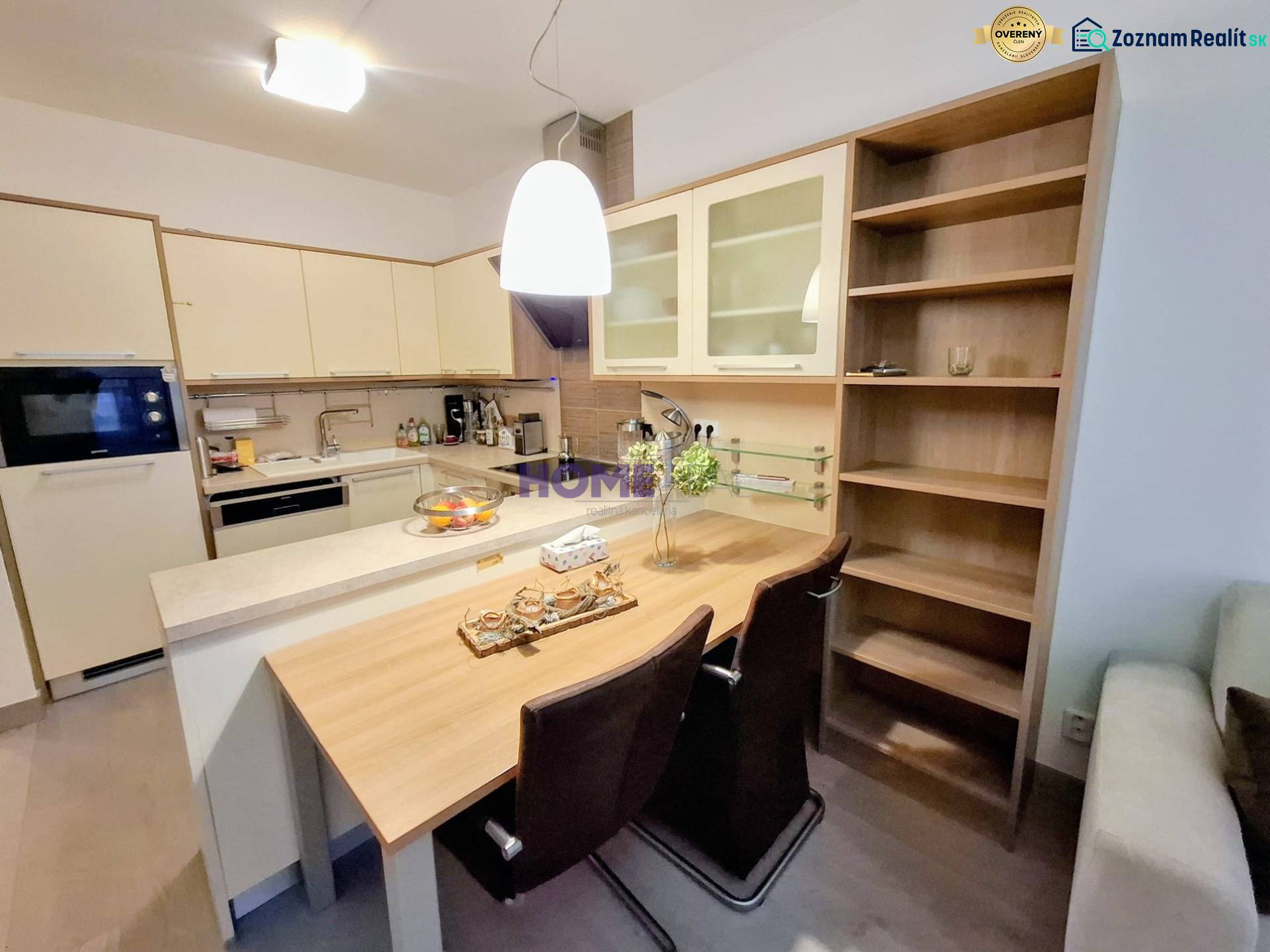 A kitchen space in a 2-room apartment with a bar counter and built-in wardrobes.