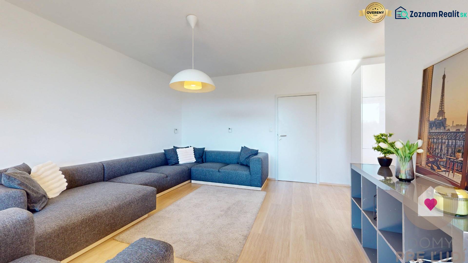 Living room with a blue sofa, wooden decor flooring, 3-room apartment.