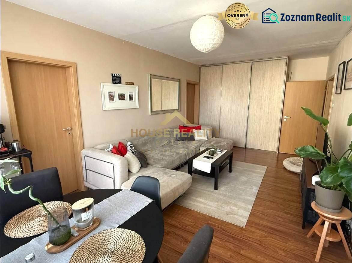 Living room in a 3-room apartment with a sofa and a table, floor with wooden decor.