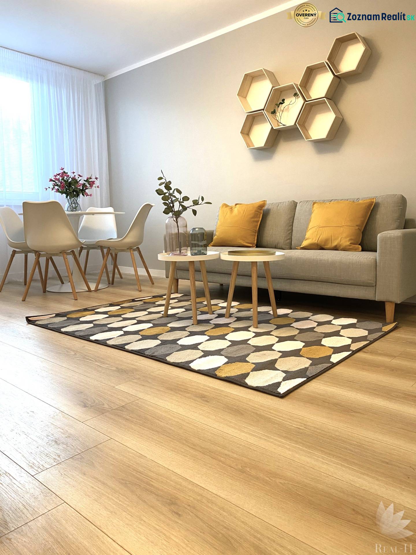 2-room apartment with wood-patterned flooring, a sofa, a dining table, and geometric shelves.