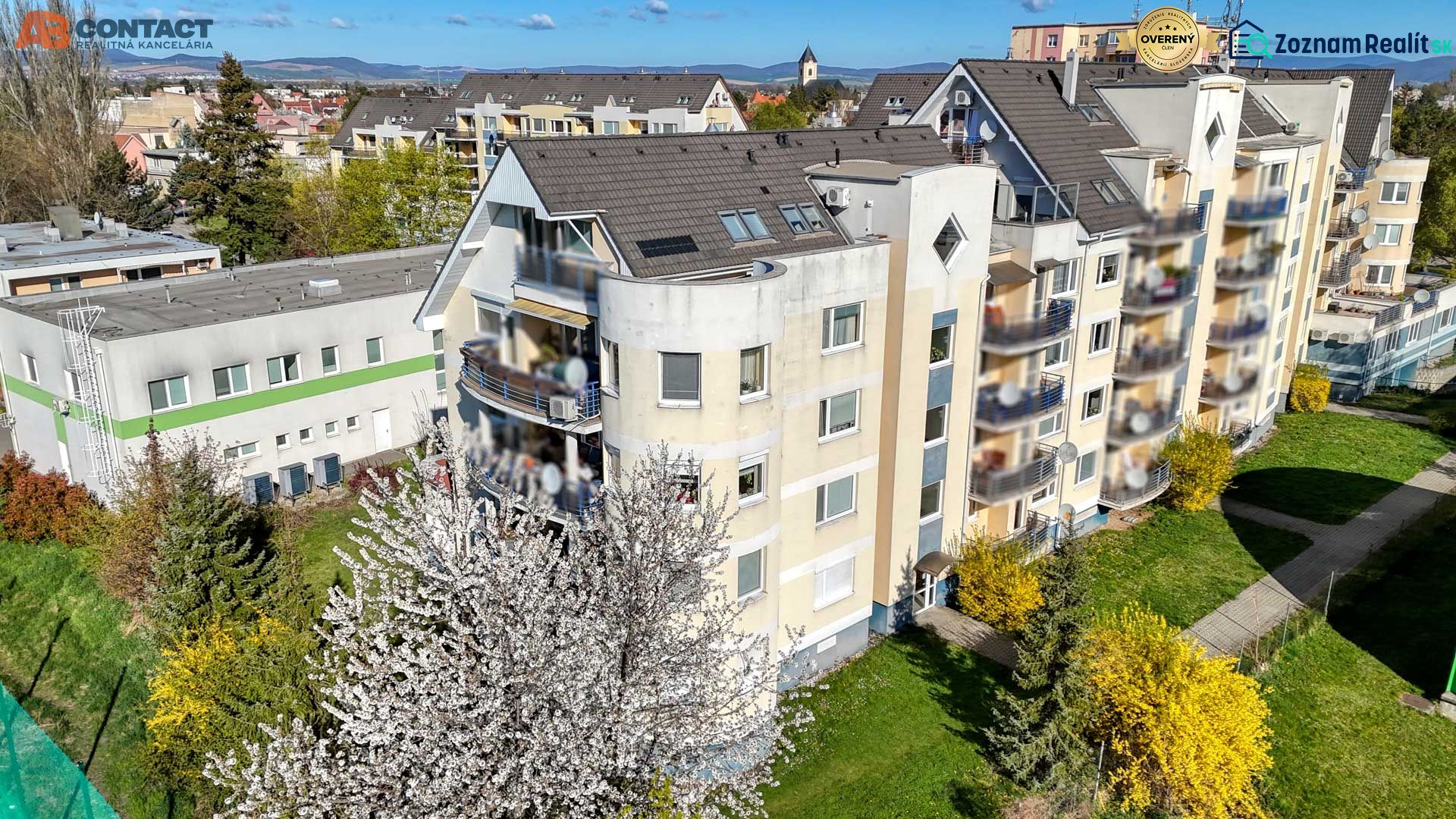 Apartment building on E. Belluš Street in Piešťany, surrounded by greenery.