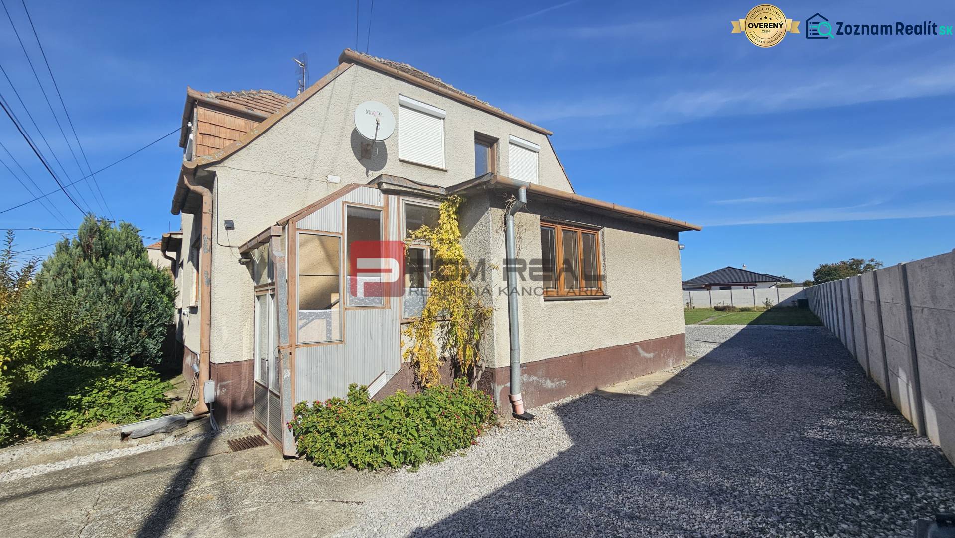 Family house on Chorvátska Street in Slovenský Grob, with a paved road on the side.
