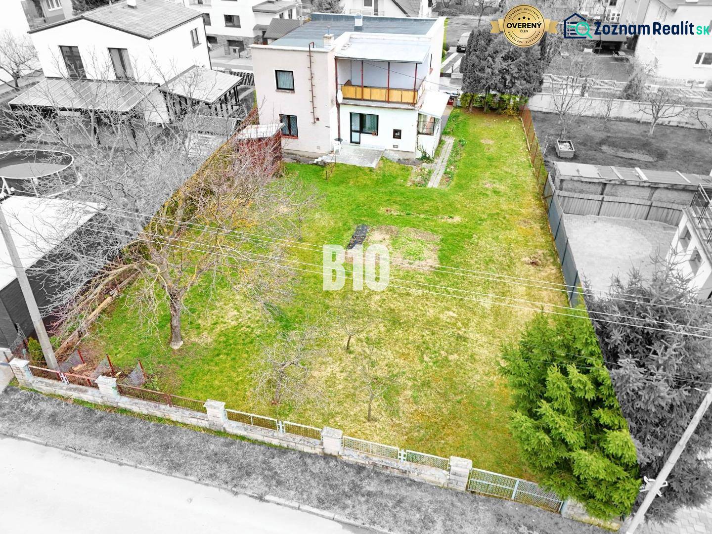 A family house in Martin with a garden and trees, surrounded by a fence for privacy.