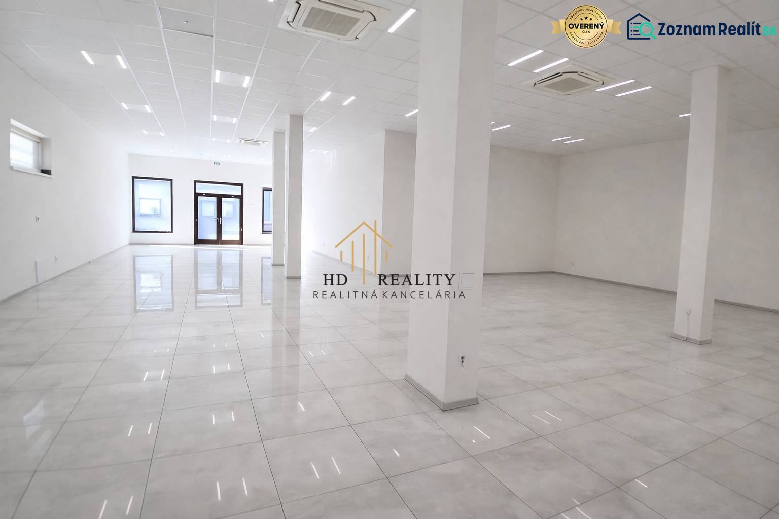 Spacious commercial spaces with white walls and shiny floors.